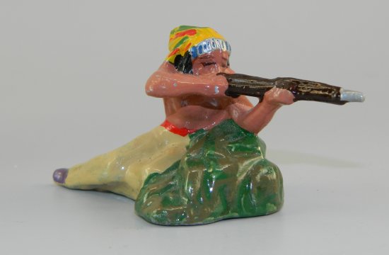 Indian Brave Crouching Behind Rock Firing Rifle