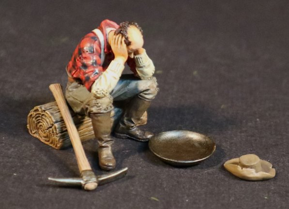 "The End of a Long Day" Miner Sitting on Log