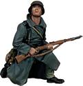 German Grenadier in Greatcoat Kneeling Looking Up